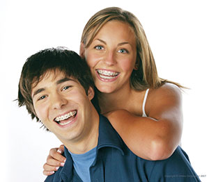 Teen age boy and girl smiling.